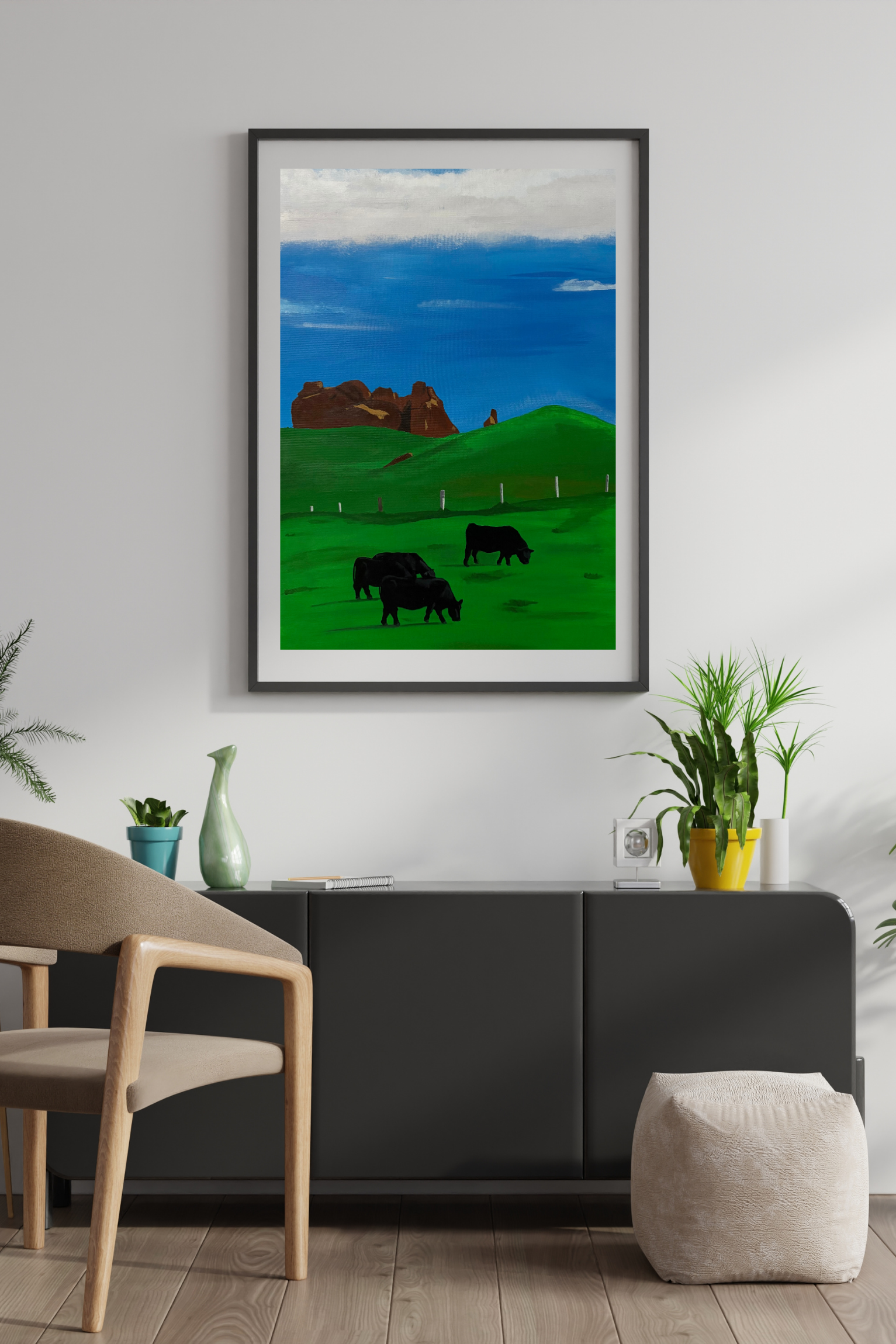 Landscape canvas artwork by Mpho Selemela depicting grazing cattle on lush green grass beneath a clear blue sky with distant rock formations.